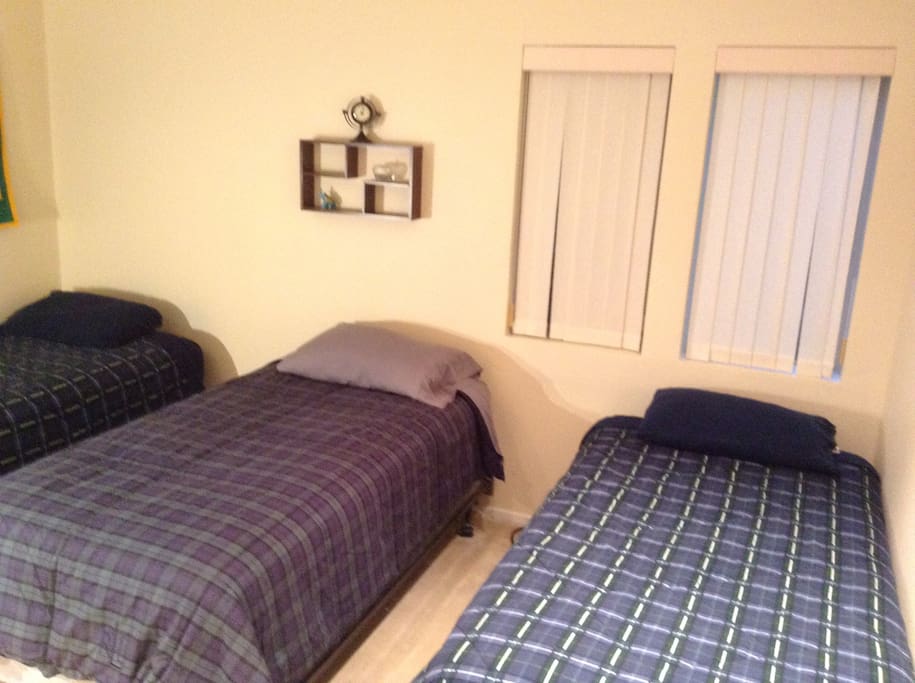 Second bedroom with three twin beds. Charging pods near each bed.
