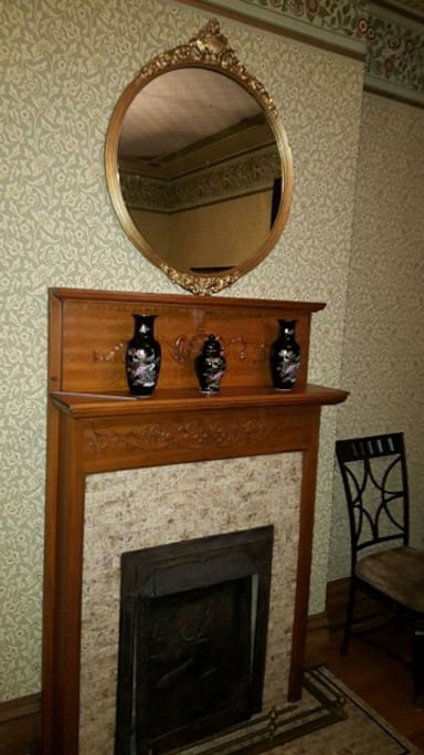 Beautiful fireplace in guestroom 1 with antique gold mirror adds to the charm.