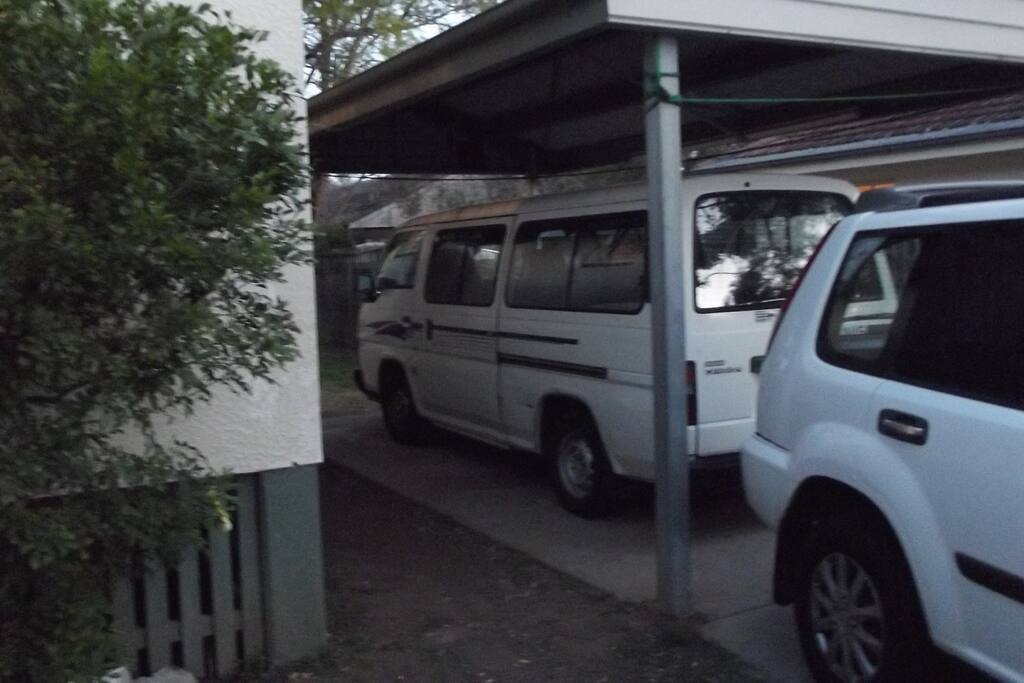 Bus size fits under cover of carport with space for another car in front