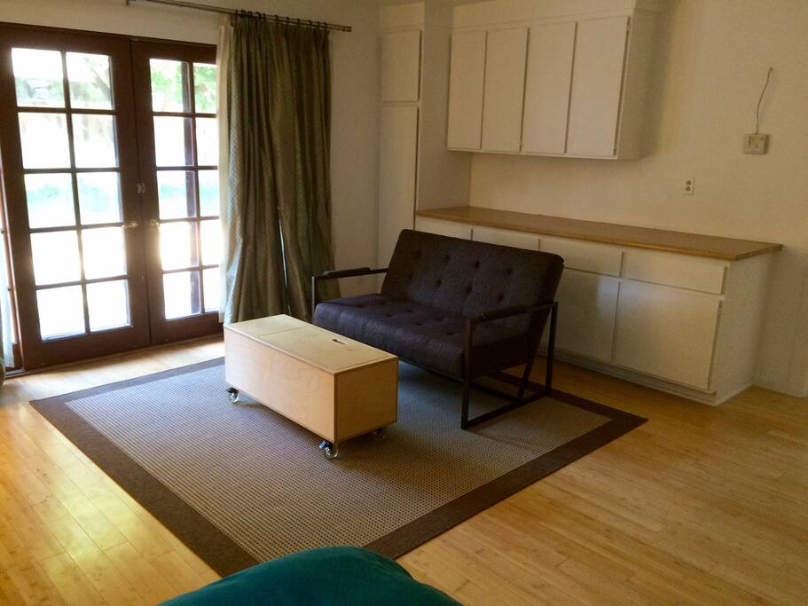 Couch area, french door, and tons of storage cabinets