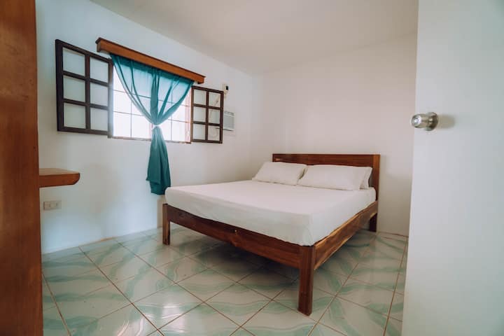 Voici une autre chambre, avec un lit queen size et la climatisation.