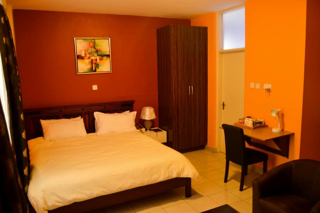 Comfortable bed, with a side cabited and lamp,large wardrobes for storage, study area
