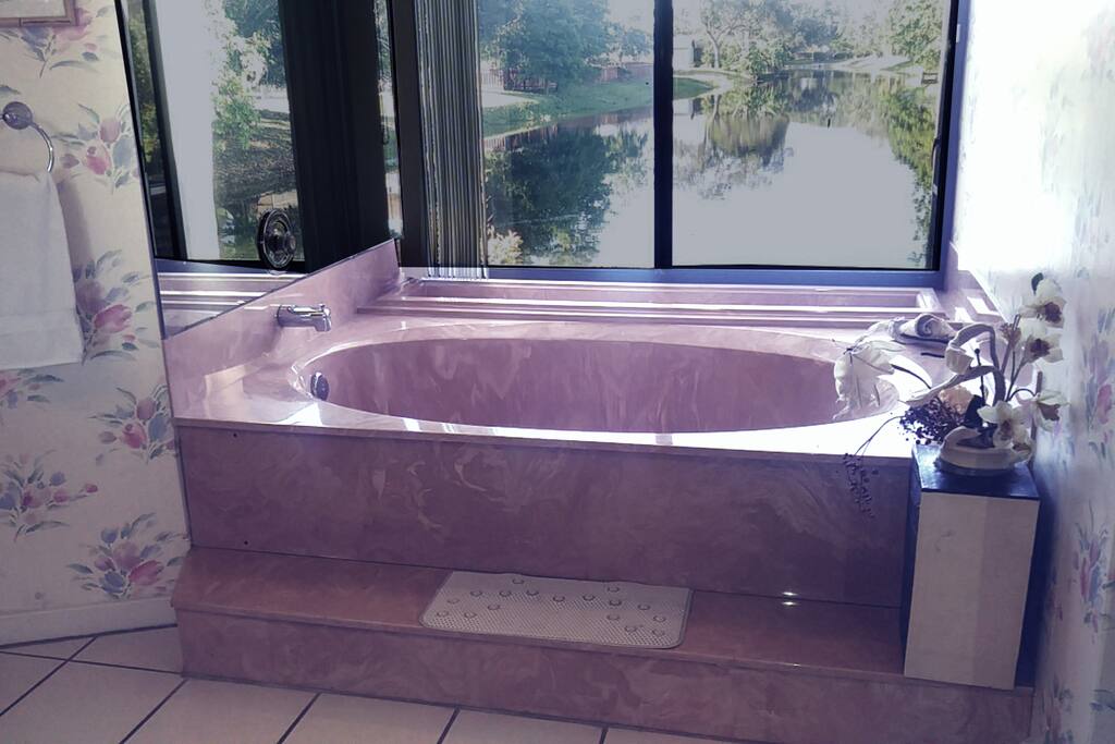 Luxurious jetted tub in the master bath overlooks the lake.