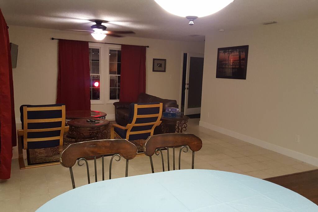 Living room w/ sofa and chairs, 40" TV w/ DVD player.