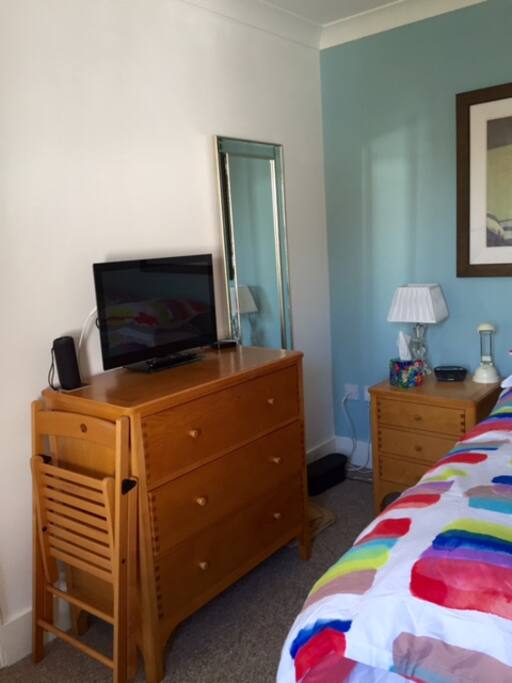 Smart tv, dressing table, bedside locker, digital radio clock