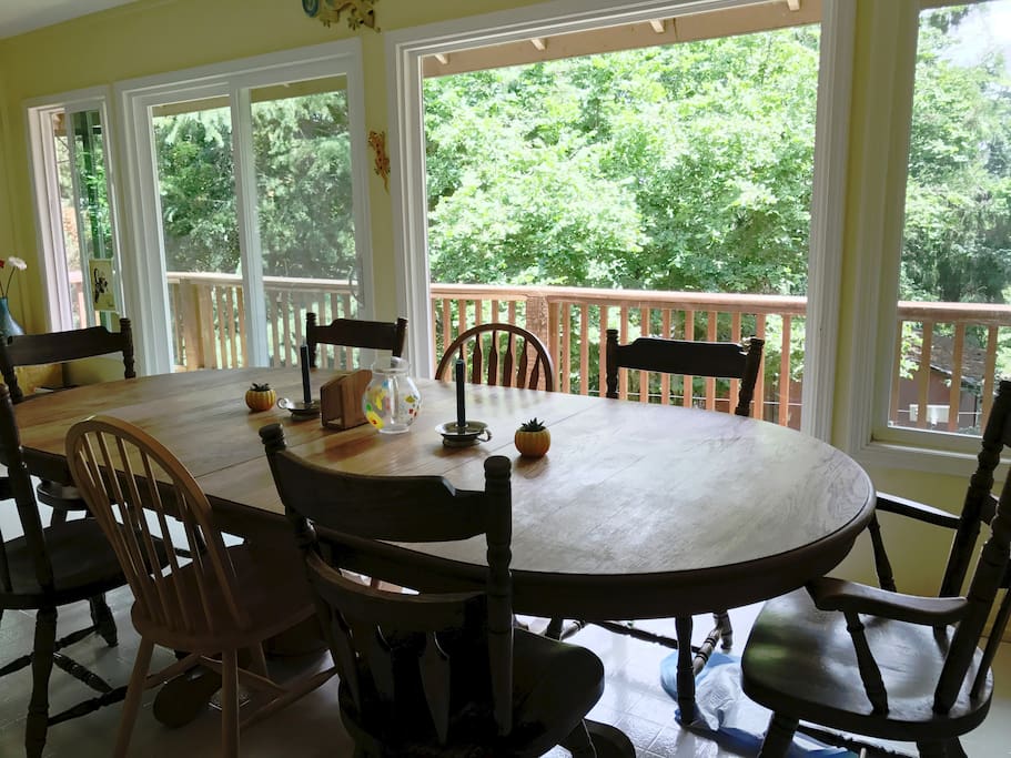 The dining area is an enclosed porch with seating available for 16 and floor to ceiling picture windows.