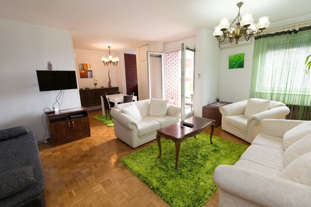 living room with dining area and entrance to balcony