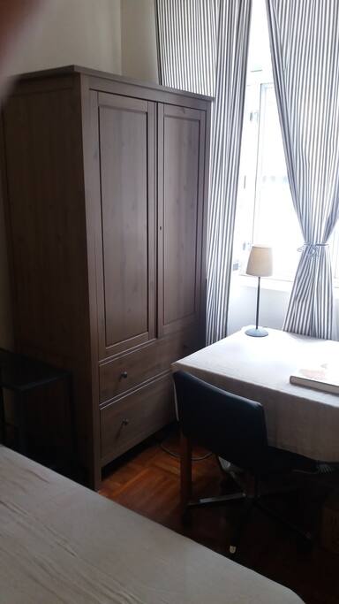 Large closet and desk, with leather swivel chair and bookcase.