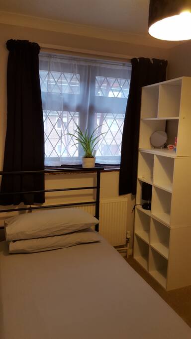 Single bed and storage cubes. Bedside lamp and mirror.