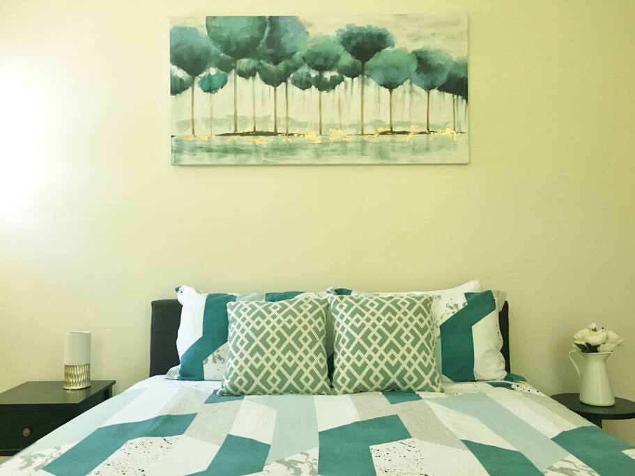 Bedroom - one queen bed with two bedside tables and a wardrobe