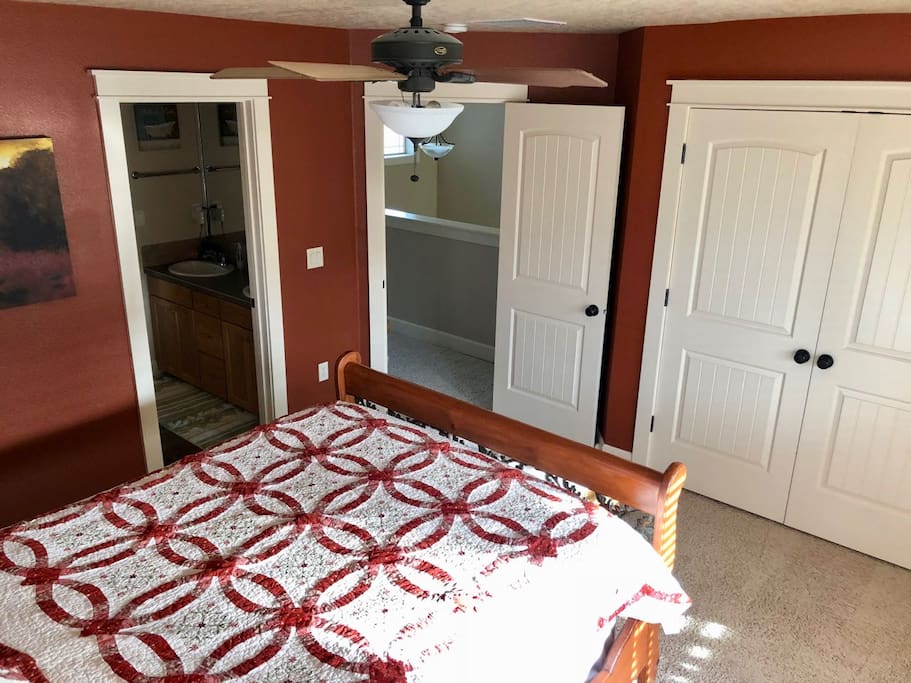 "Red" room, showing closet doors on the right (extra blankets, towels, etc), middle door to foyer balcony (mini kitchen), and door on left to Jack 'n' Jill bath