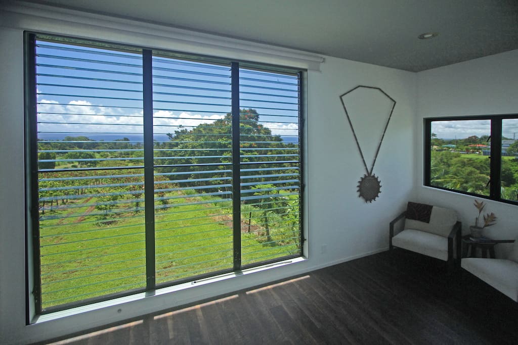 Enjoy the giant bedroom window overlooking ocean and cacao orchard.