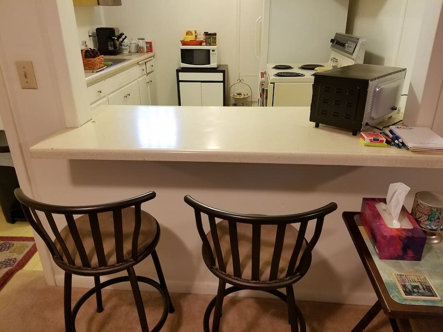 Counter with 3 stools, one on back side