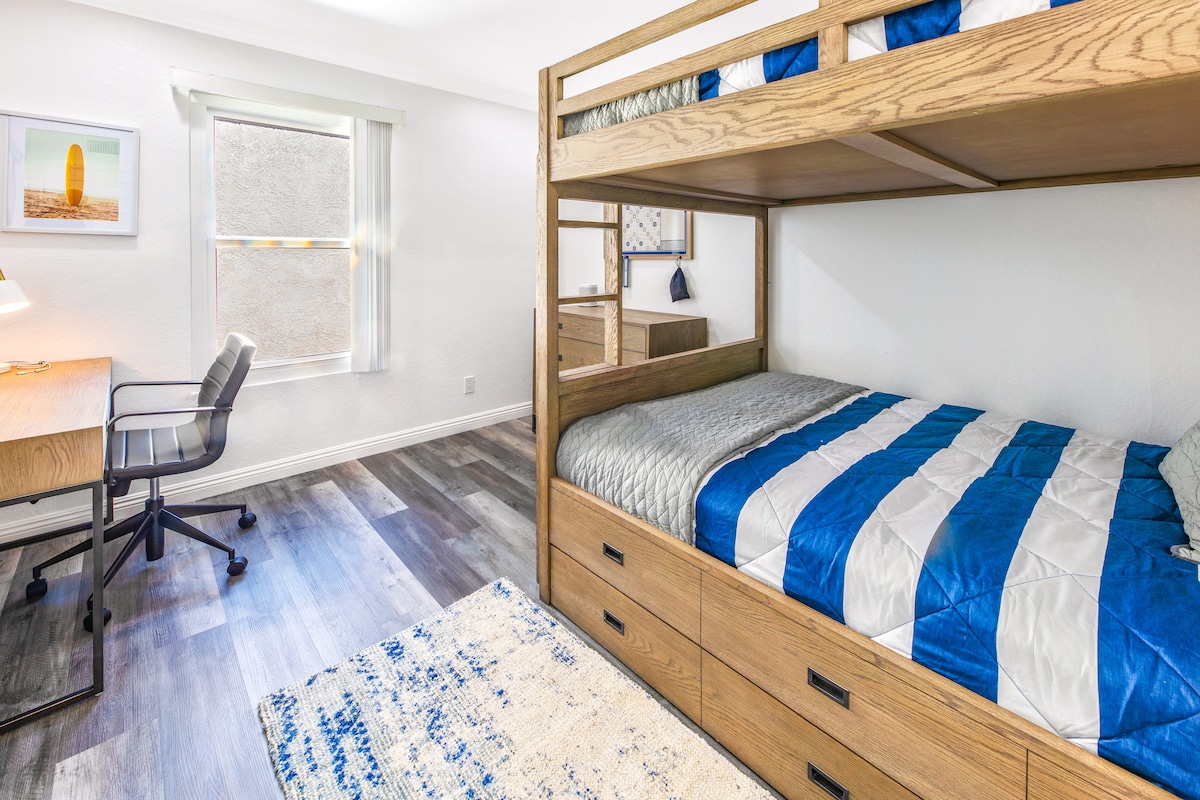 3rd bedroom upstairs w/ full over full bunk beds with 3rd full trundle  (sleeps 6!) and desk/ workspace.