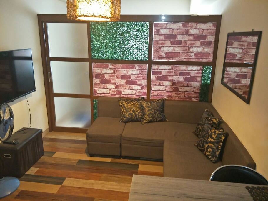 relaxing living area with comfortable sofa and 50 inches TV.