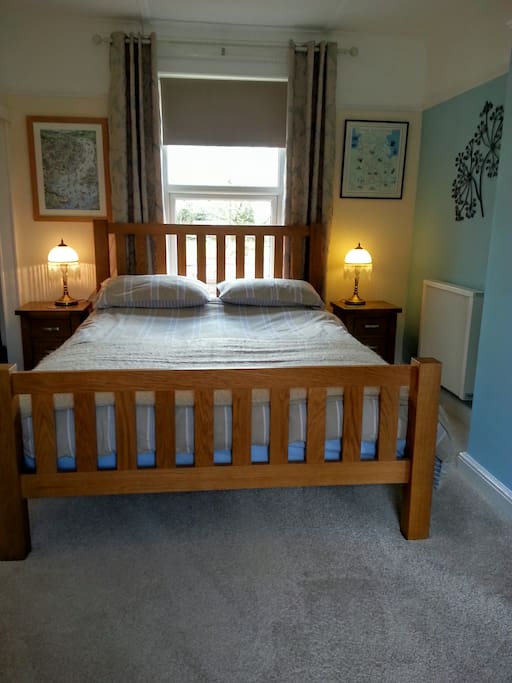 A comfortable King sized bed, also in this room wardrobe, dressing table and television.
