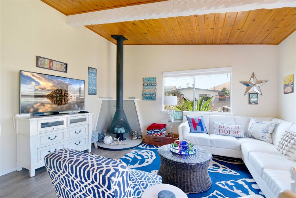 The living room is nicely furnished and has a large flat screen TV and DVD