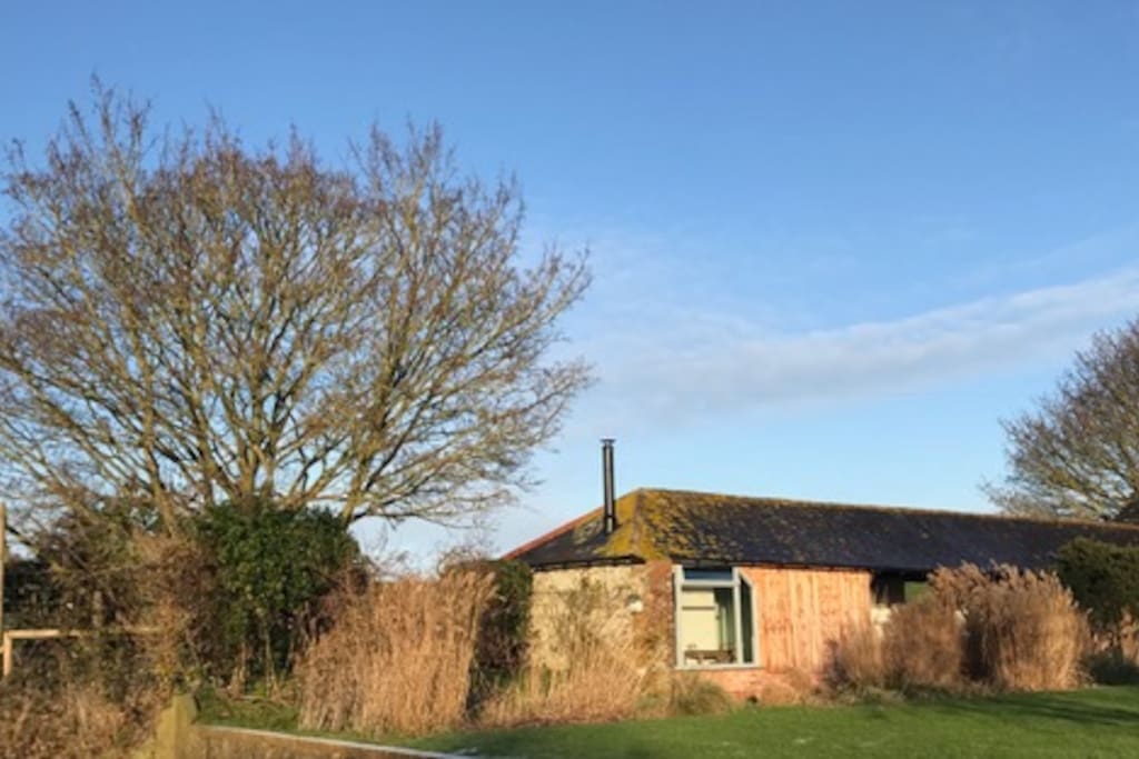 Viewing deck with beautiful views over fields. Adjacent to guest barn with its own wood burning stove and underfloor heating.
