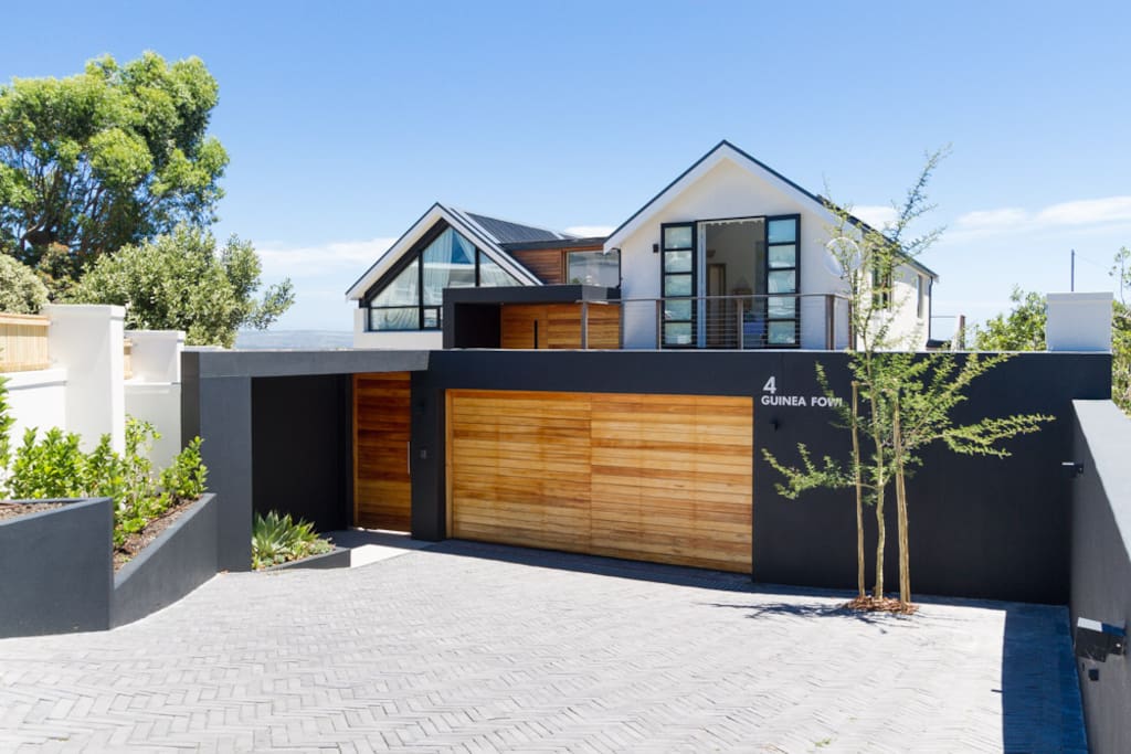 The home from the front by daylight. Double garage and a seperate entrance with security intercom system