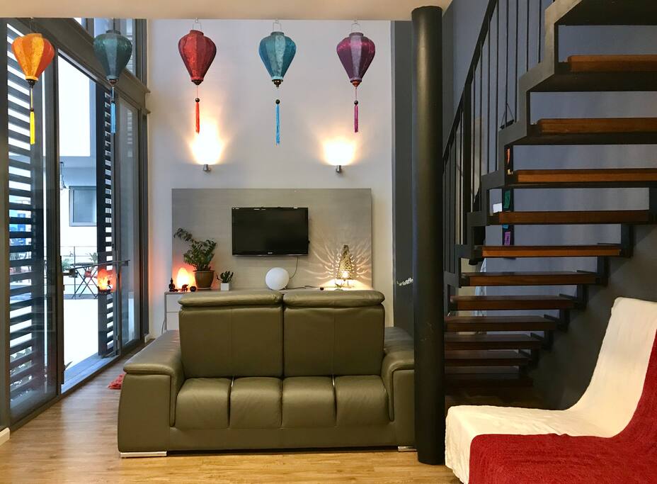 Living room and sofa bed under stairs