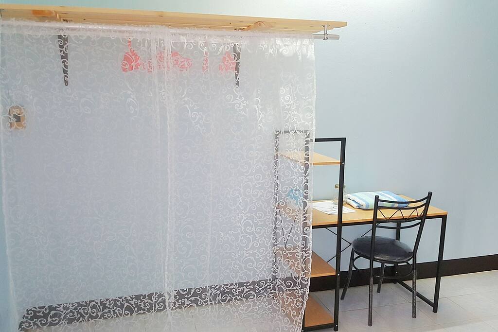 opened wardrobe and working table