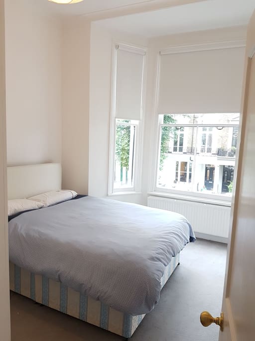Main bedroom with a king-size bed. Lots of air and natural light.