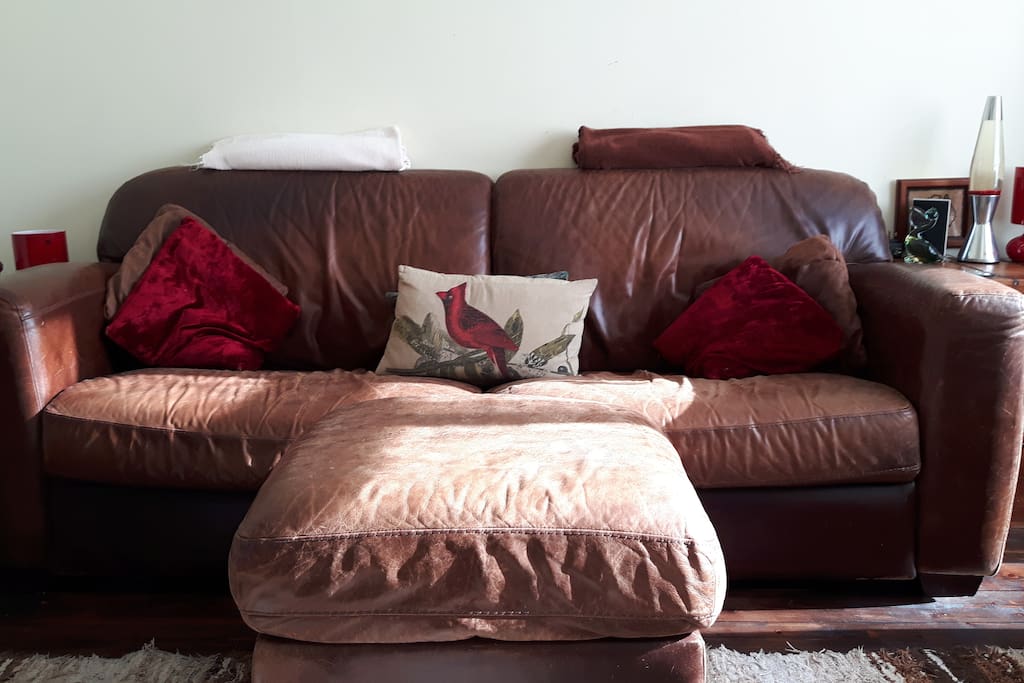 Large comfy main sofa with cushions and blankets