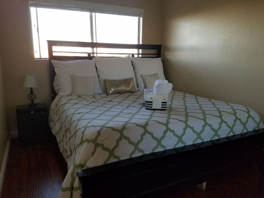 Cozy king sized bed, with clean, fresh linens and towels, and COLD WATERS in your bedside minifridge