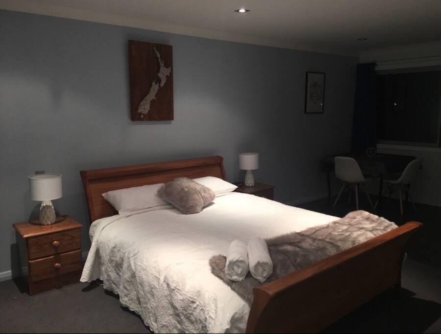Lovely private bedroom upstairs with ensuite bathroom, view of our front lake, table and chairs, desk space and television.