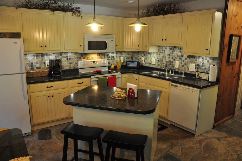Fully Equipped kitchen with bar for extra seating