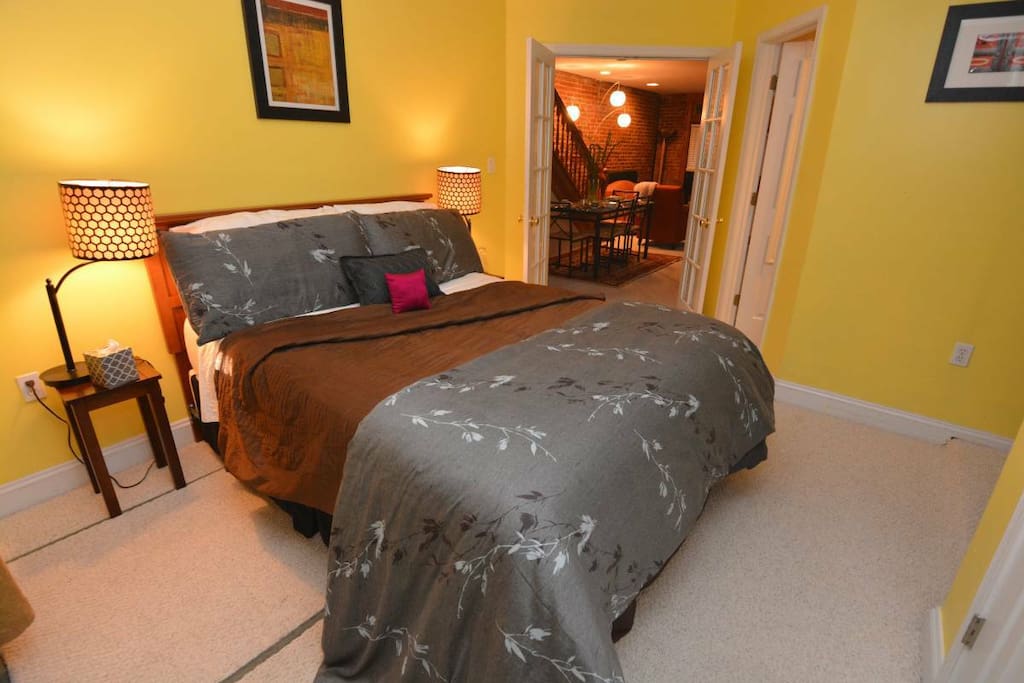 Spacious bedroom has a queen-size bed and luxurious linens