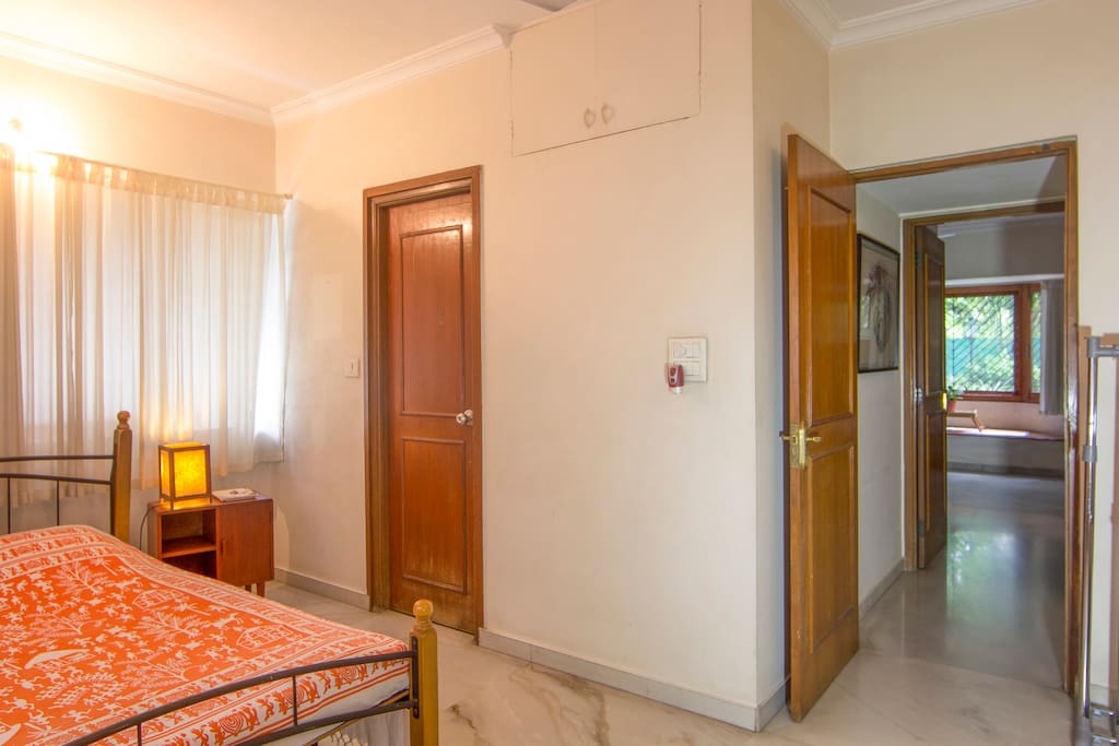 The bedroom with a view of the entrance and the door leading up to the ensuite bathroom.