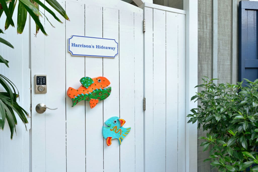 Gate to Harrison's Hideaway with Morris Johnson colorful fish welcoming you!