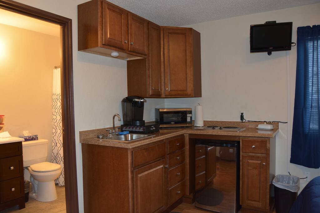 The kitchen has a Keurig, microwave and stainless cooktop. Perfect for a quick meal. The TV is on a full motion mount so you can watch it from any corner.