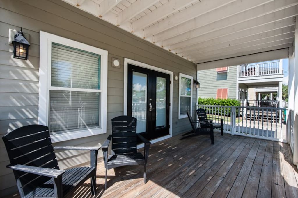 Nice front porch invites you to spend quality time relaxing when not on the beach.