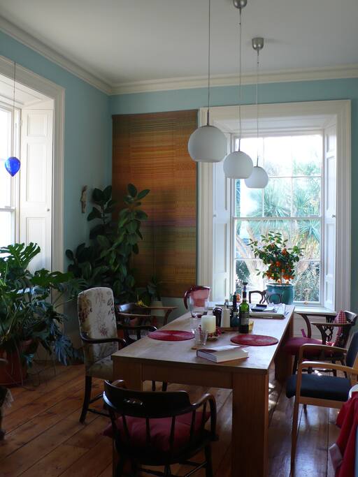 The breakfast table is bright and surrounded by greenery.