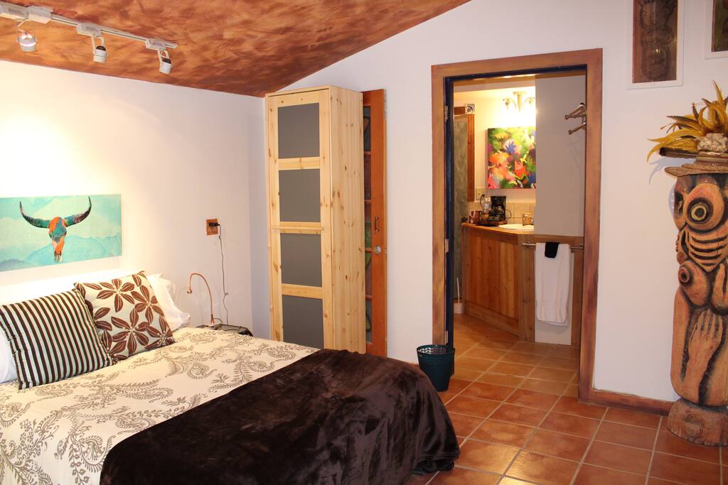 Full bed with entry to the sink room. There is a door that divides this area.