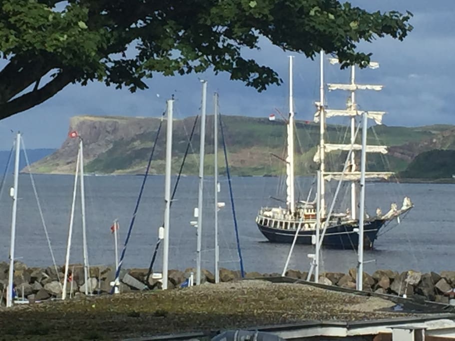 View from house of Bay and Fairhead. Beyond Fairhead Scotland is visible (just 9 miles away!). The tall ship Thalassa is a regular in the bay.