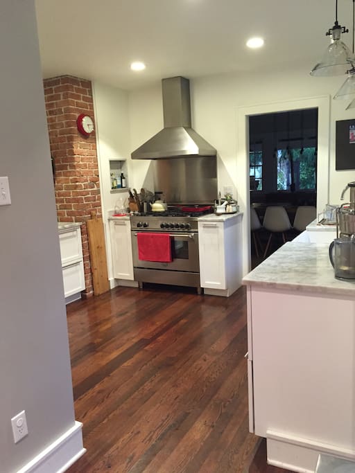 Bright kitchen with gas stove, juice + espresso machines