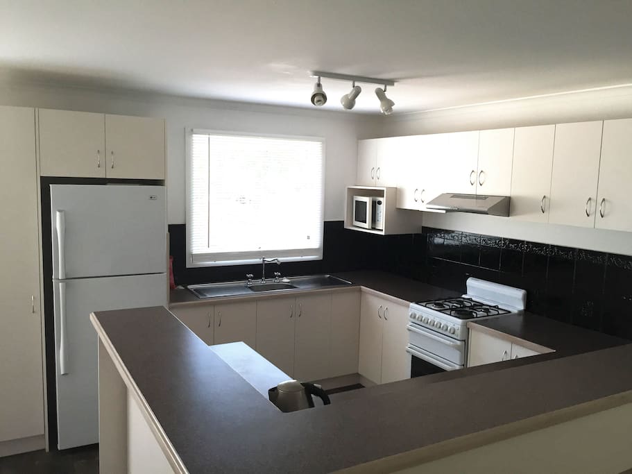 Fully equipped kitchen with relatively new fridge and appliances.
