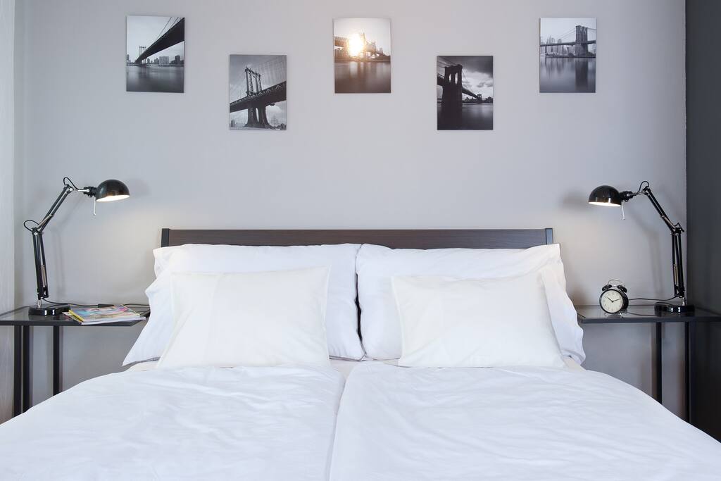 Comfortable queen size bed with bed lamps