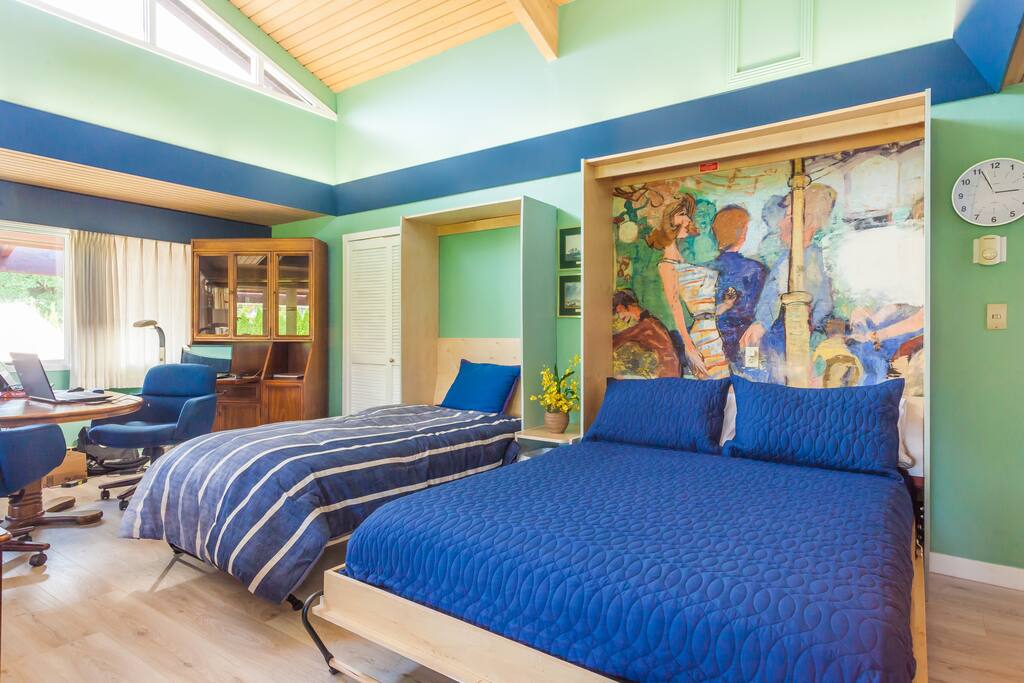 Same view with beds down. White kitchen door closed, wall beds on a different day from a different angle. Easy to fold up. There is plenty of room even with beds down