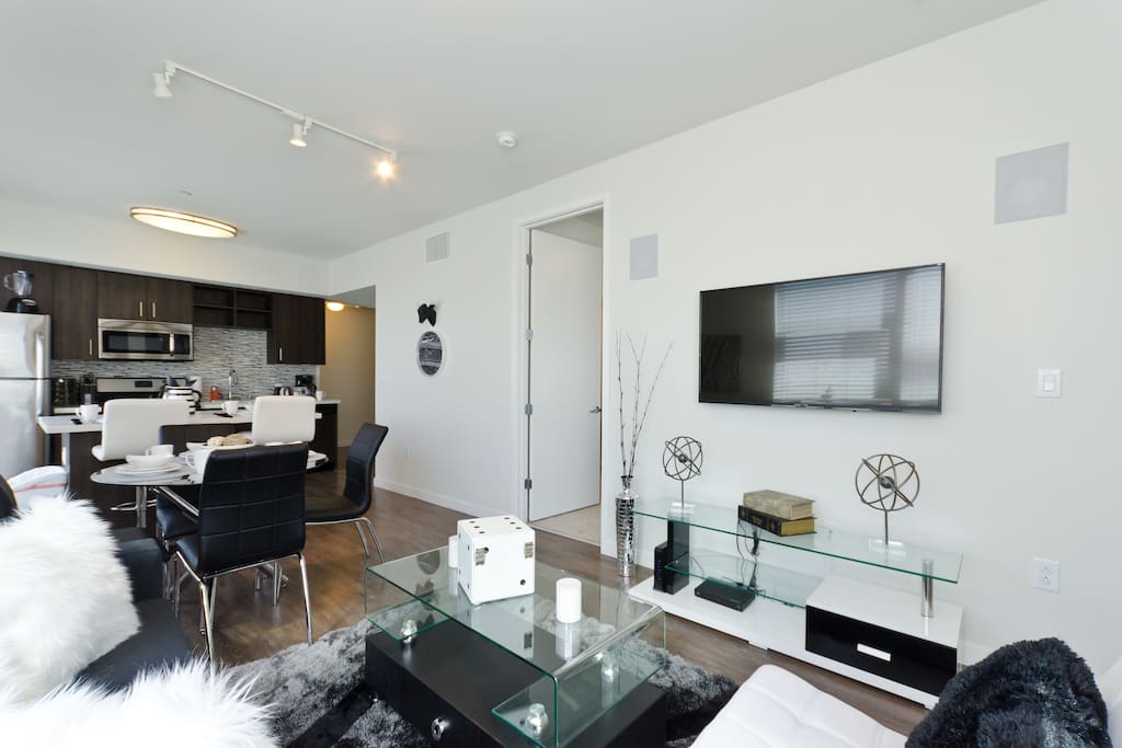 Large living room with 60 inch HD TV and cable