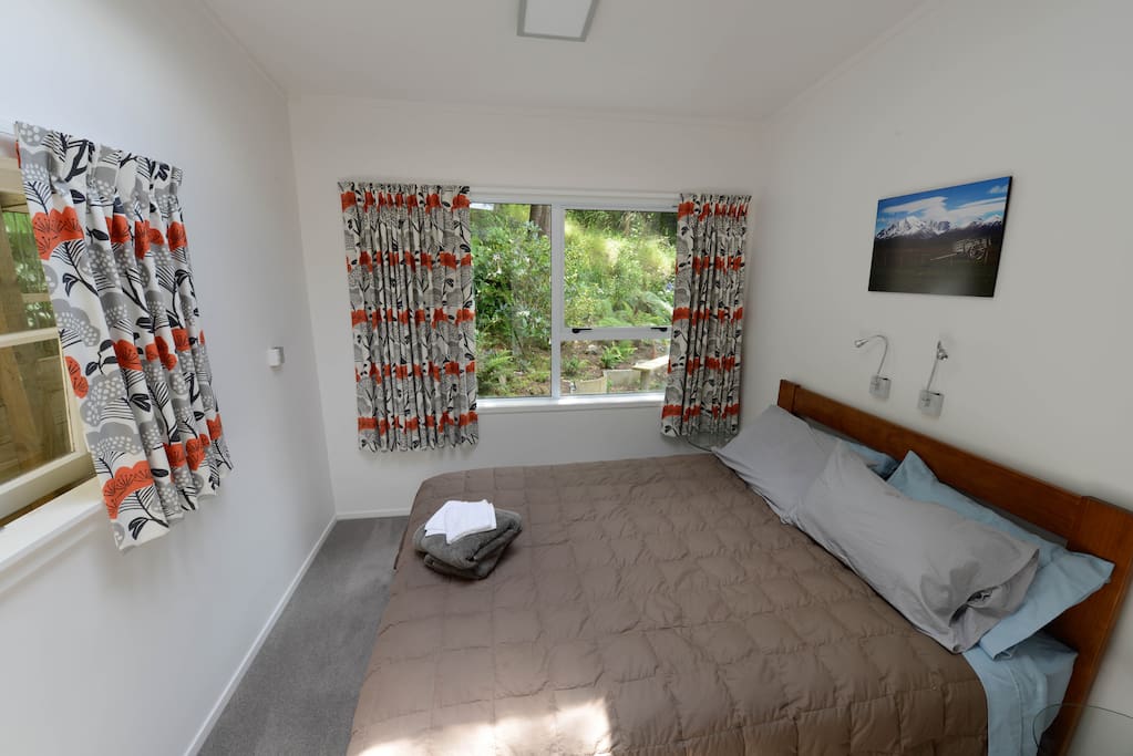 Queen bed with comfortable mattress. Sleep in peace lulled by the local Ruru (owls).