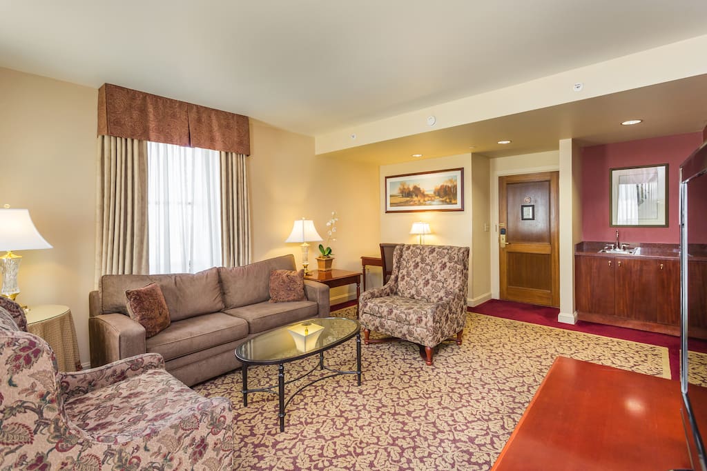 The sitting room is furnished for contemporary comfort while watching TV, or engaged in conversation.