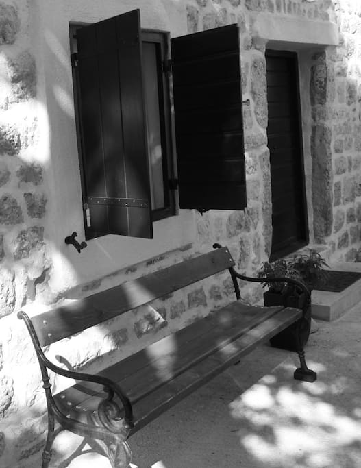 The downstairs entrance to the house with lovely sage plants and a bench to sit and ponder