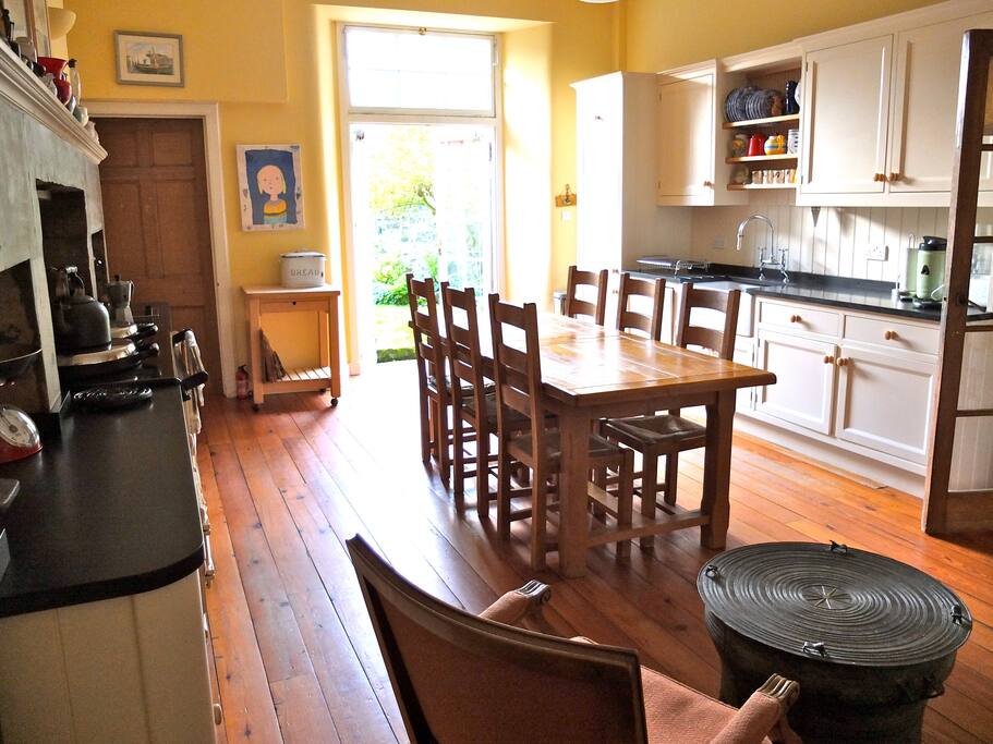 Wood-floored Aga kitchen/dining opening on garden.