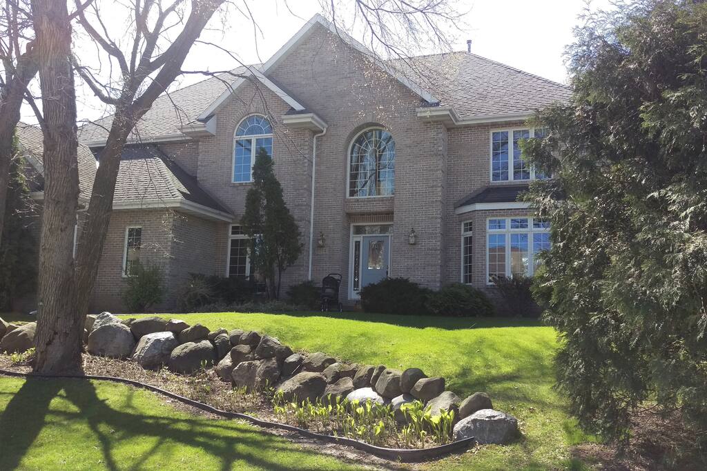 Beautiful McMansion on wooded lot facing west on a hill.