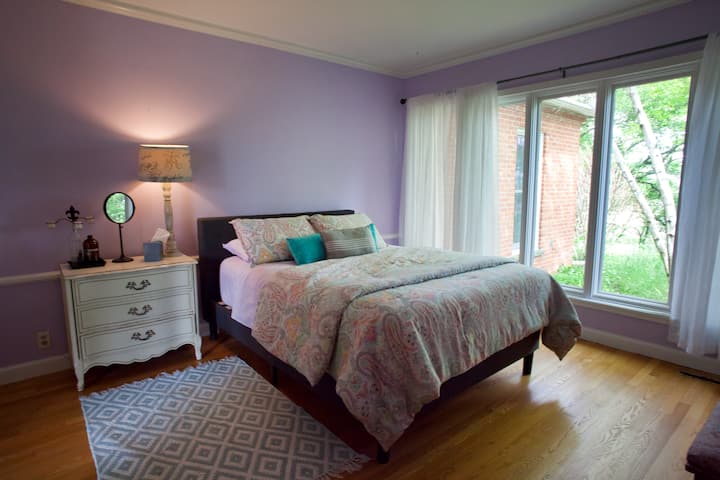 Second bedroom off the main floor hallway with queen bed and sunrise views.