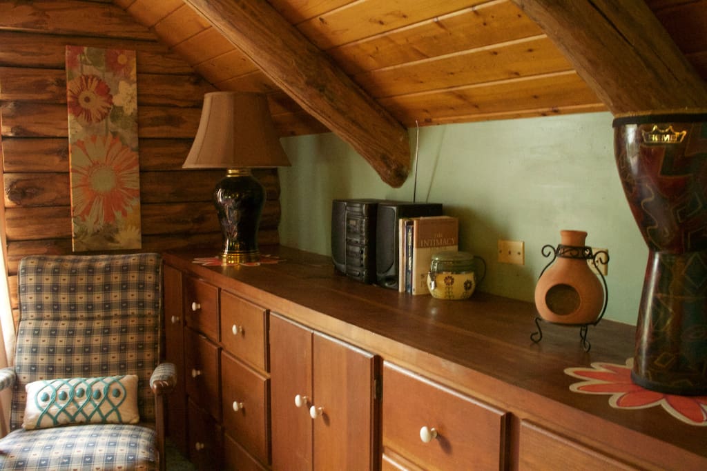 Handsome log interior room with cherry built ins and vaulted ceiling creates warm and cozy yet roomy feel.